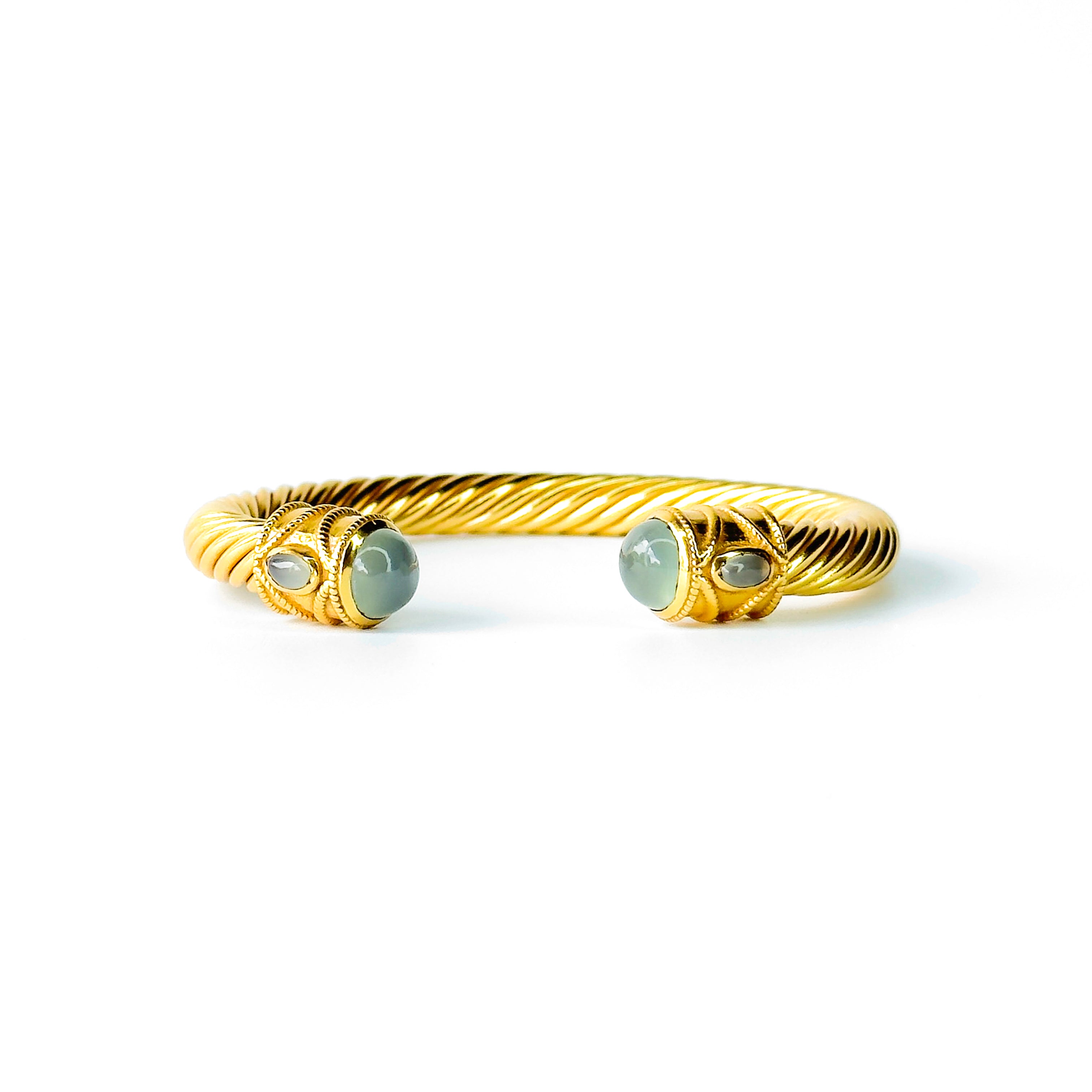 Twisted gold cuff bracelet with light green gemstone end stones
