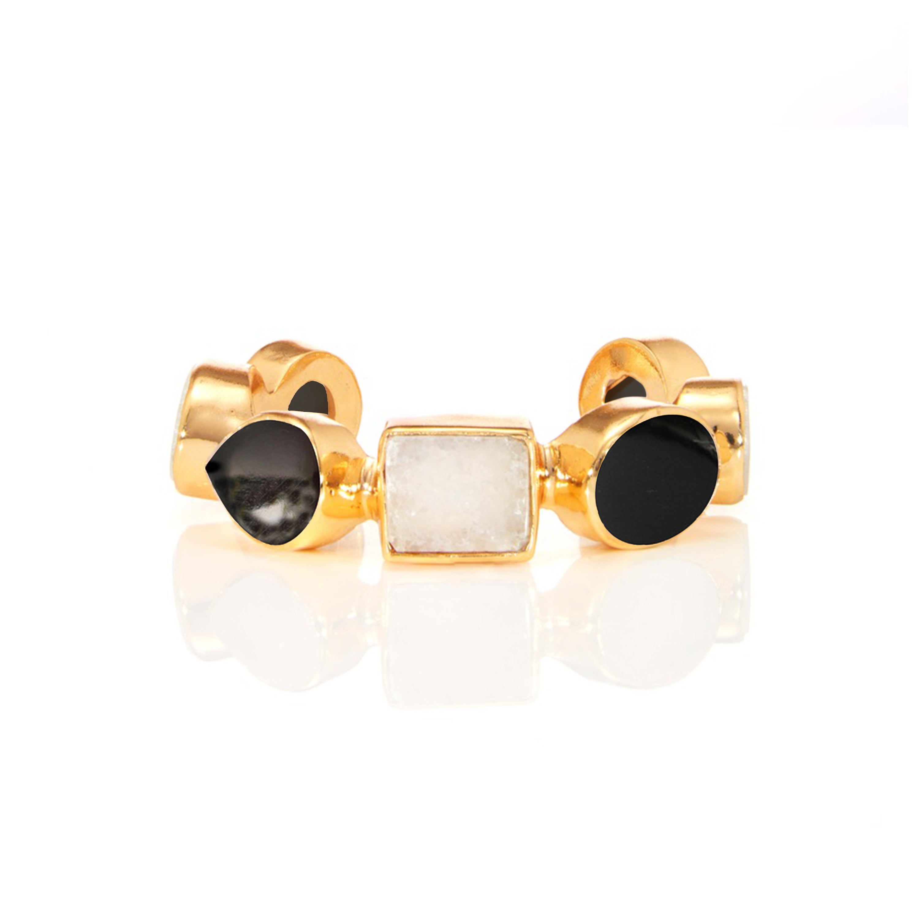 Gold statement ring with rectangular white gemstone and black stone accents