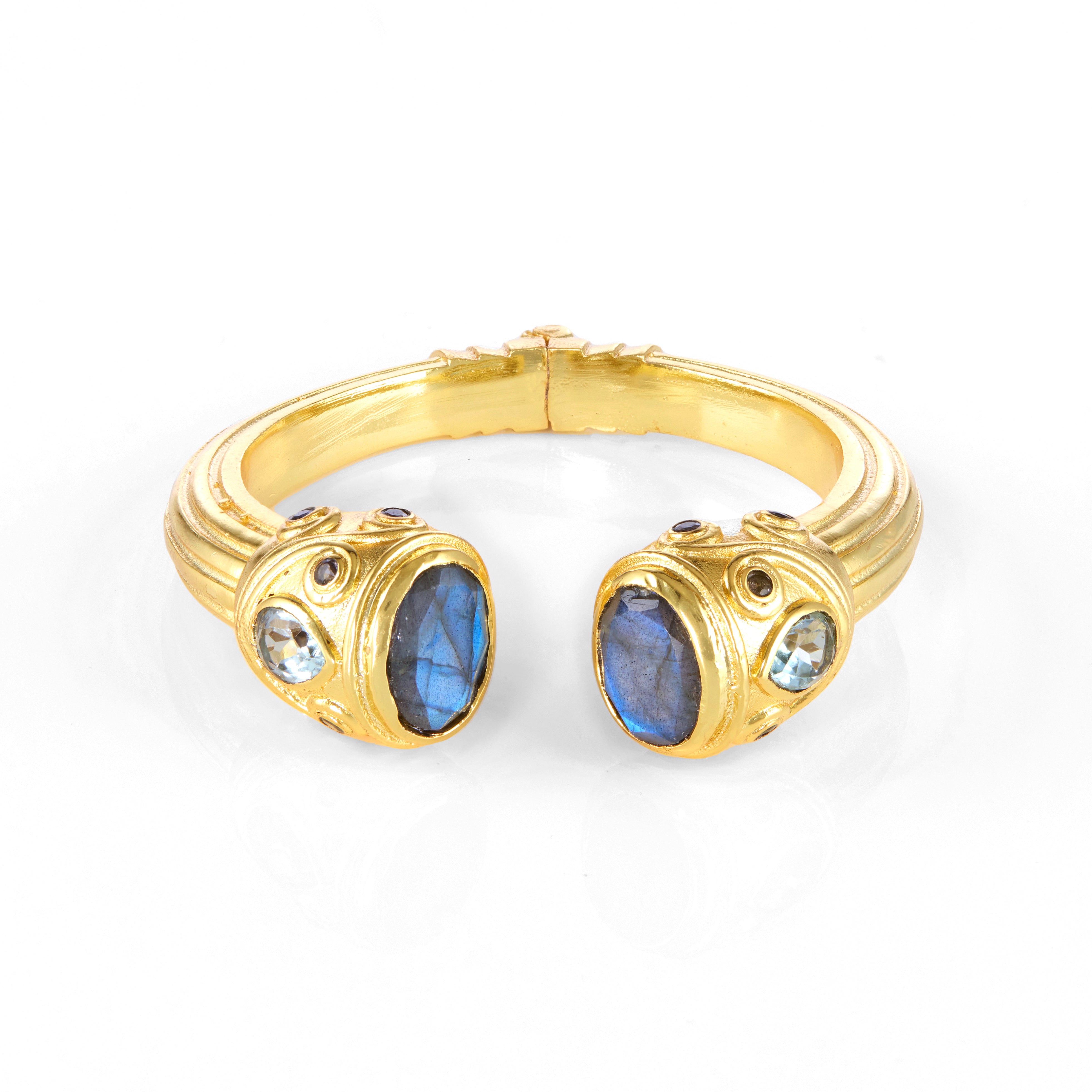 Gold cuff bracelet with blue gemstones