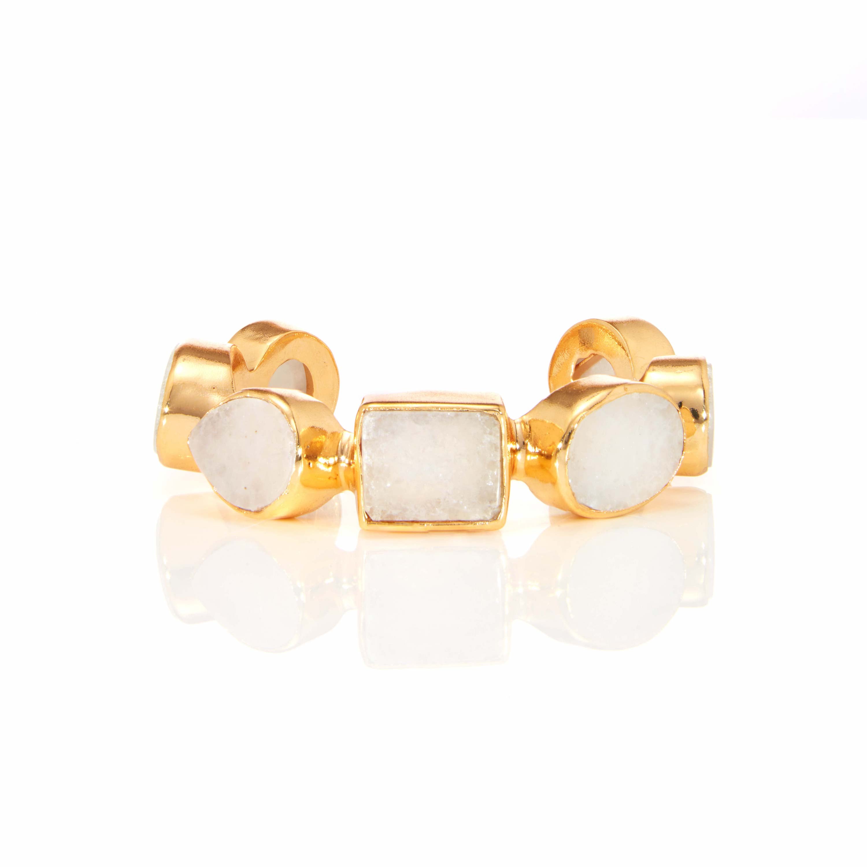 Gold statement ring with oval white gemstone cabochons