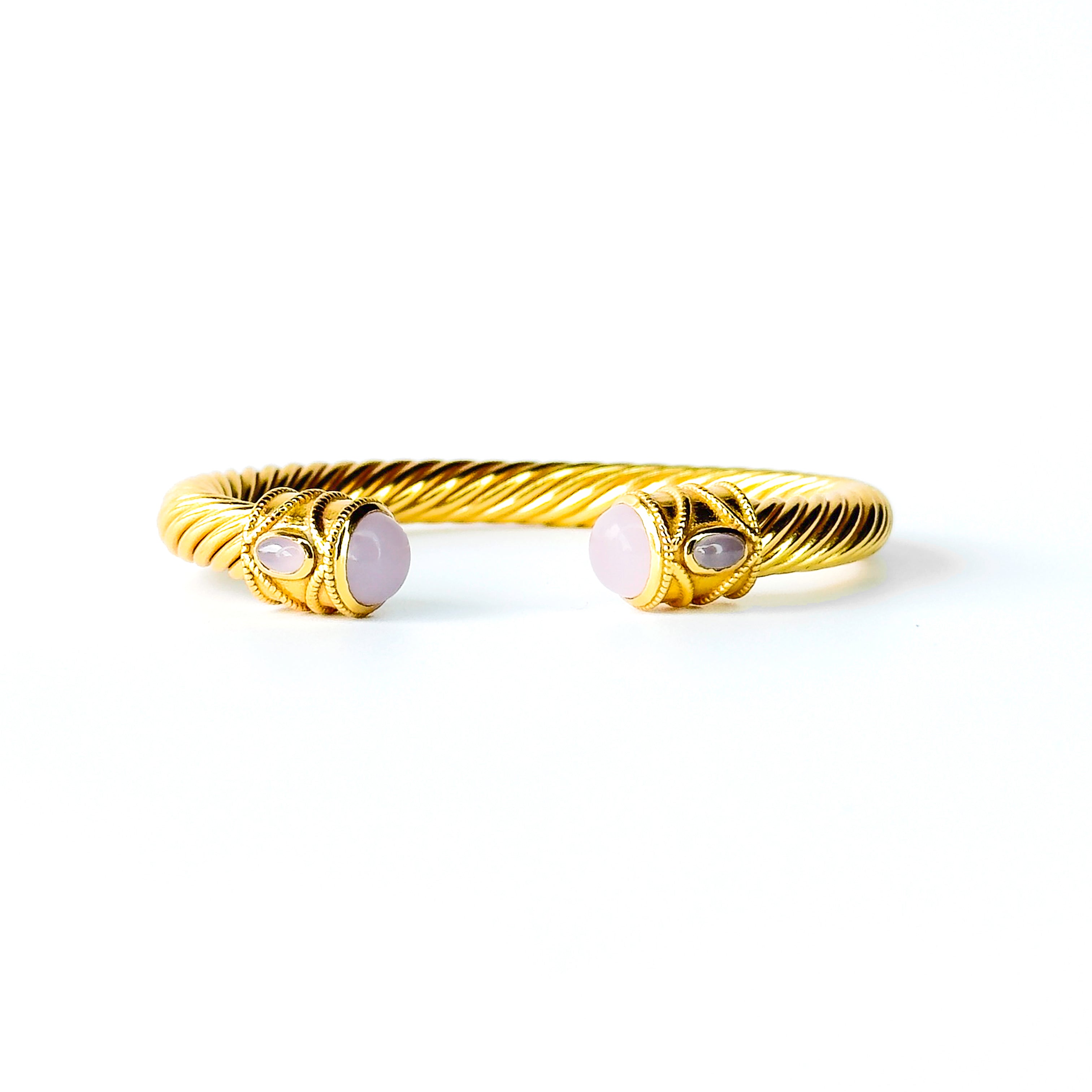 Twisted gold cuff bracelet with pink gemstone end stones