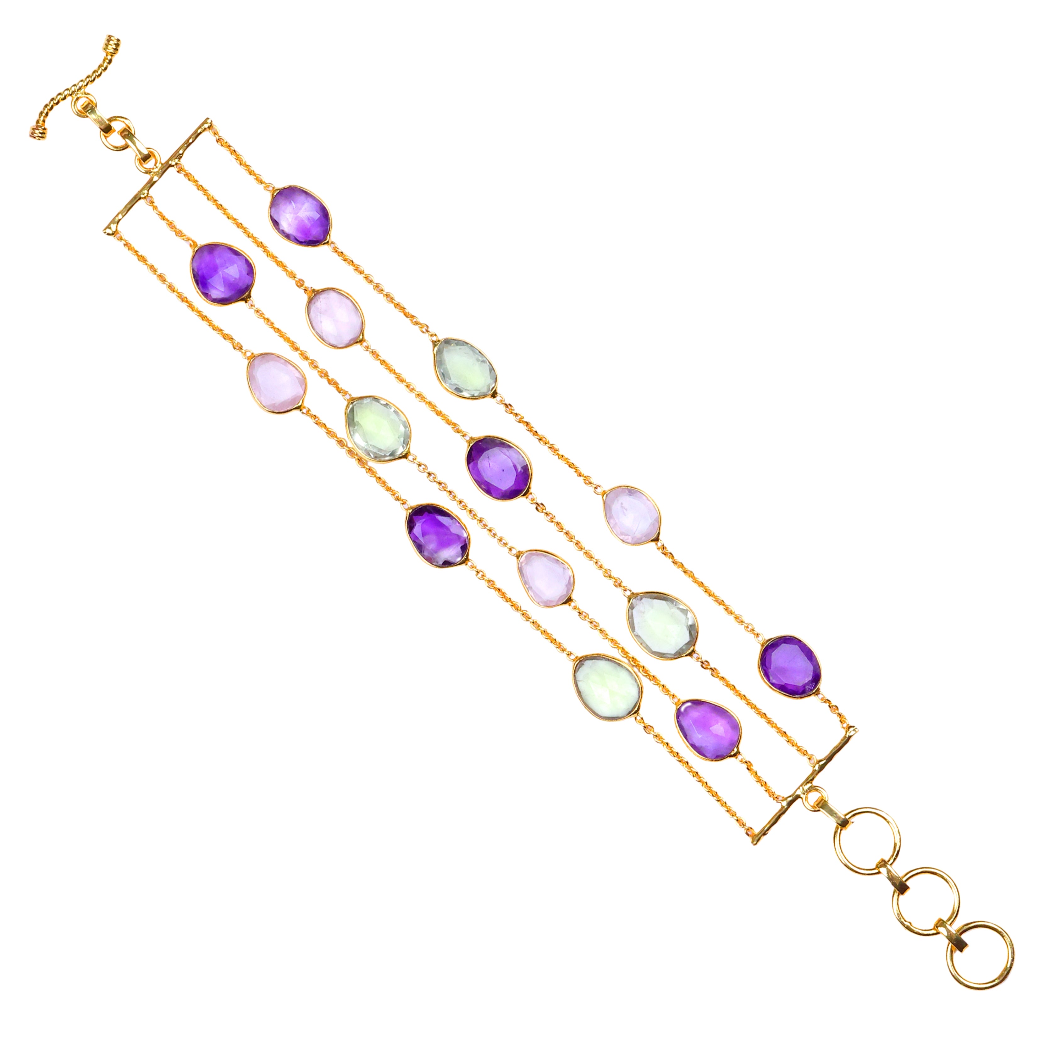 Gold multi-strand bracelet with purple, green and clear gemstone accents