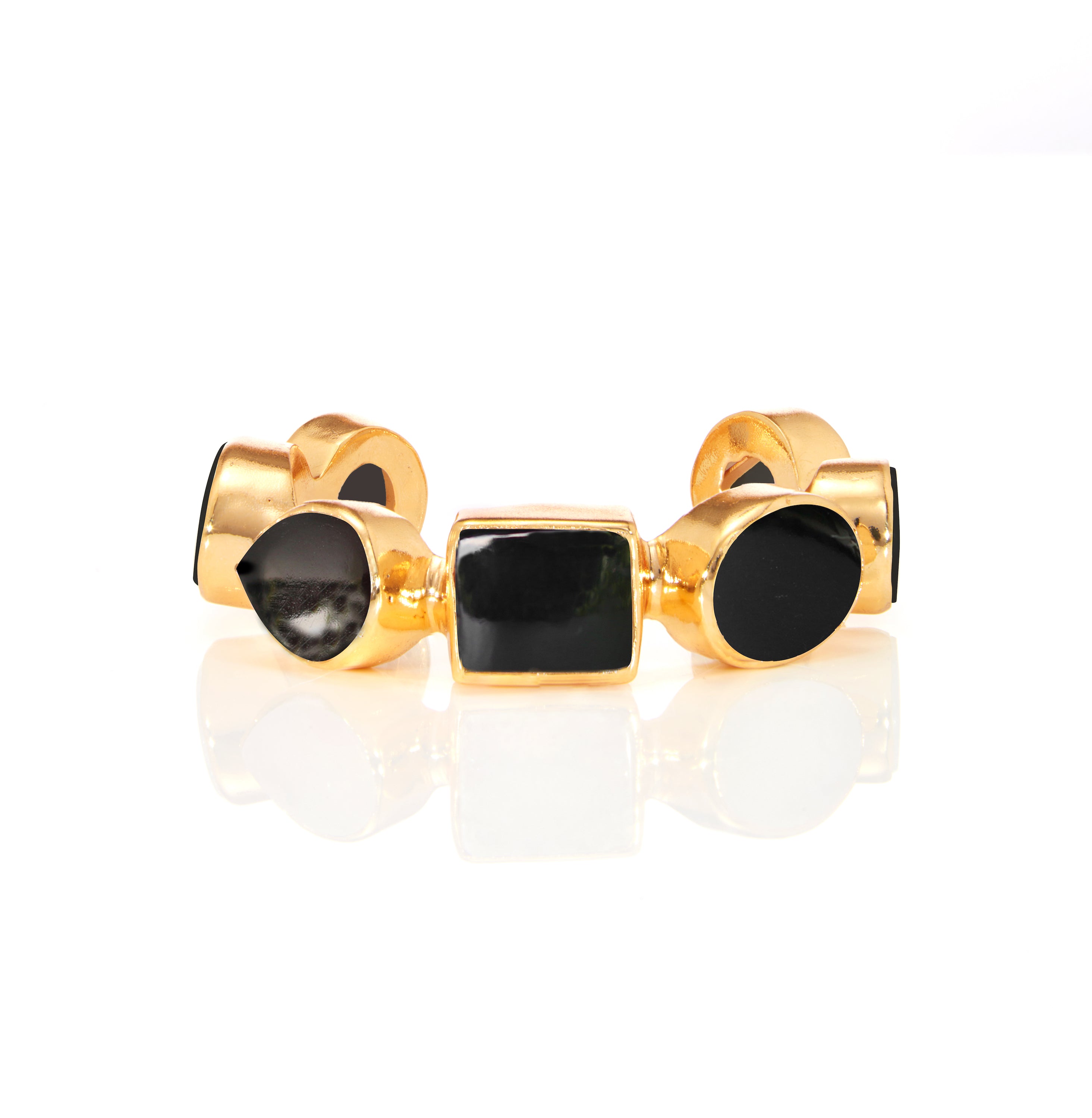 Gold ring with black gemstone center and round side stones