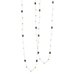 A sterling silver necklace with a layered design featuring bezel set sapphire, kyanite, and larimar studs, adorned with small blue and green stones.